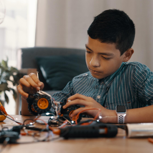 Boy building robotic toy car home